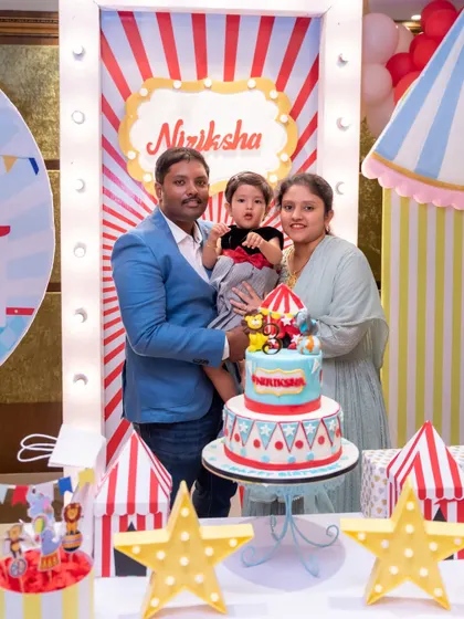 A happy family portrait at a circus-themed birthday party. We ensure we get a wonderful photo of the birthday child with their parents.