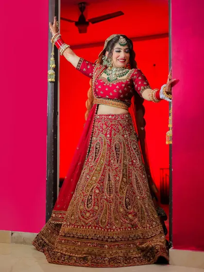 A joyful bride making her entrance, framed by a brightly colored doorway.