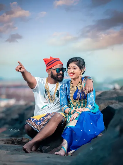 A candid moment of conversation and connection. The groom-to-be points out at the sea, sharing a moment with his partner during their Agri-Koli themed shoot.