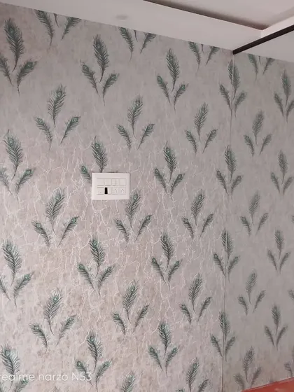 A subtle wallpaper with a repeating green peacock feather motif.