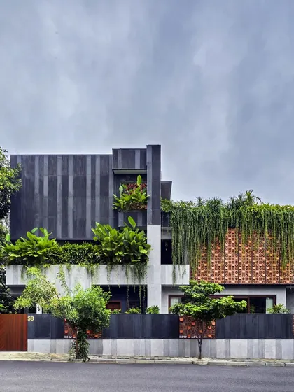 In Project 58, the architecture becomes a living entity, almost disappearing behind a cascade of greenery. We used a combination of black stone, custom terracotta screens, and dense vertical planting to create a home that is truly porous and integrated with its landscape.
