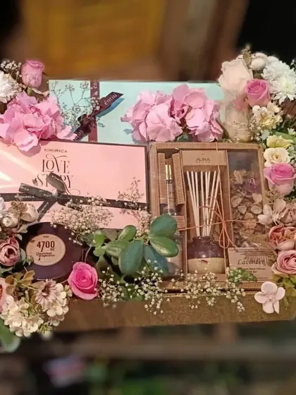 Personalized wedding gifts for the happy couple. This large crate is filled with pamper kits, gourmet popcorn, diffusers, and fresh flowers to celebrate the newlyweds.