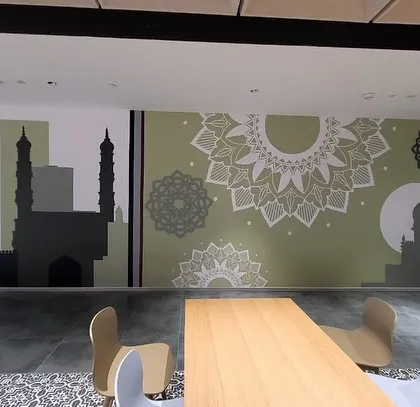 The abstract Hyderabad mural seen from the seating area, providing a culturally relevant and modern art piece for employees to enjoy.