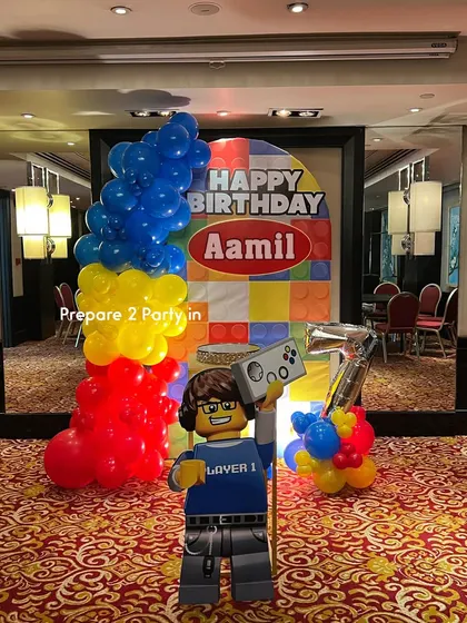 See more of the Lego-themed setup, including a custom cake stand and different angles of the vibrant balloon and backdrop combination.