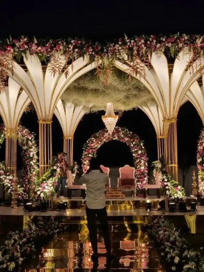 A breathtaking nighttime view of a grand, multi-level mandap, showcasing our expertise in large-scale productions.