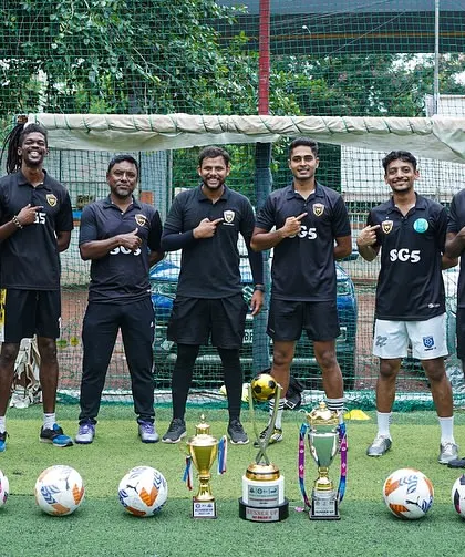 Our coaching staff standing proud with the trophies our teams have won. Their expertise and dedication are the foundation of our success.