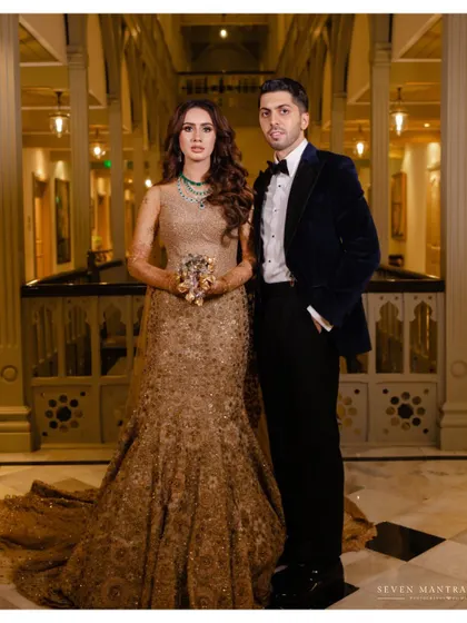 A modern royal portrait. The bride and groom's pose has a formal, editorial quality, perfect for the grandeur of the Taj Mahal Palace.