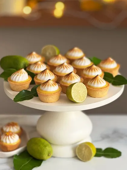 A beautiful display of my Gondhoraj Lime Meringue Tartlets. The zesty lime curd fills a crisp tart shell, topped with a perfectly torched meringue kiss. It’s a bite of pure hope and freshness.