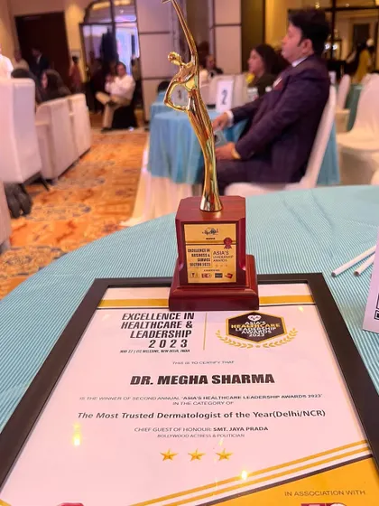 The trophy and certificate for "The Most Trusted Dermatologist of the Year (Delhi/NCR)". This award motivates me to continue upholding the highest standards of patient care and trust.