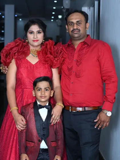 A beautiful family portrait. I designed the mother's red gown and the son's matching tuxedo for his birthday party.