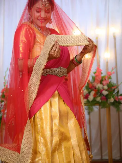A playful moment captured, showing the beautiful net davani with a golden border that completes the half saree set.