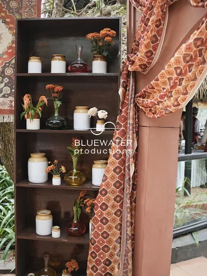 A shelf filled with small vases of flowers, adding a touch of softness to the rustic decor.