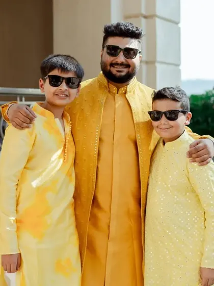 The groom with his younger family members, all dressed in coordinated yellow kurtas for the Haldi ceremony. I can create custom outfits for all ages.