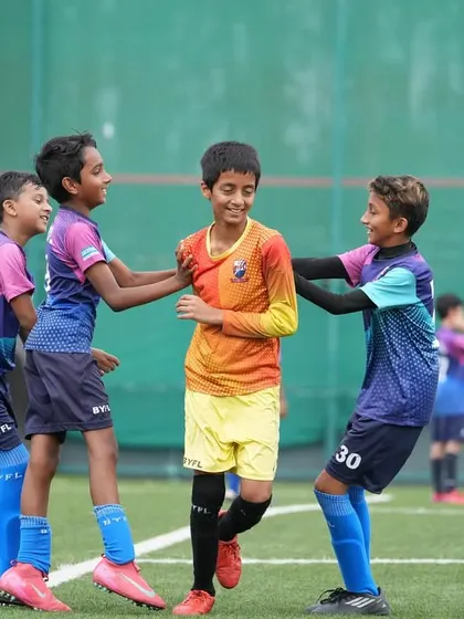 Teammates celebrating a fun moment on the pitch. These are the memories that last a lifetime.