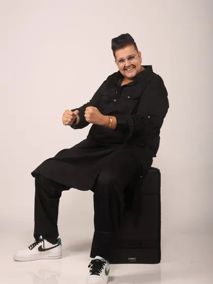 Another shot from my photoshoot, showing my energetic and fun-loving personality. The all-black outfit with fresh sneakers is a classic look for me.
