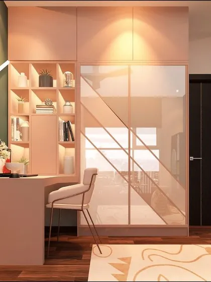 A stylish kid's room with a pink and green color scheme, featuring a corner study desk and a wardrobe with a unique diagonal glass design.
