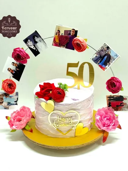 This 50th anniversary cake features a creative photo arch, showcasing cherished memories of the couple. The design is finished with red roses and gold hearts, making it a deeply personal and celebratory cake.