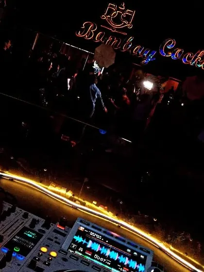 The view from my console at Bombay Cocktail Bar, with the neon lights and the crowd setting the scene for a great night.
