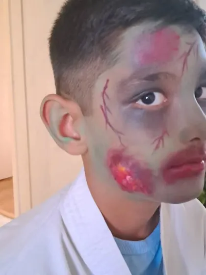 An example of costume prosthetic makeup. For this zombie look, I used special effects techniques to create the illusion of bruised, decaying skin and bloody wounds, perfect for film or a Halloween costume.