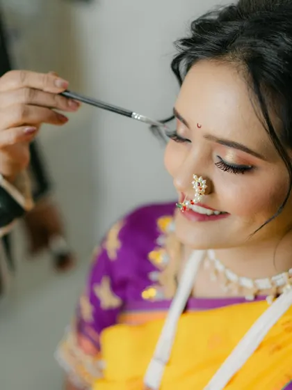 A gentle touch. This photo captures a moment during the makeup application, showing the care and precision I take with every bride.