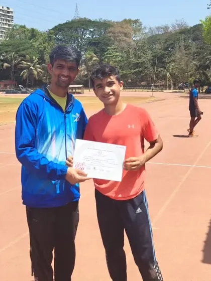 Coach Firoz presenting Yuv with his certificate, recognizing his dedication and recent successes.