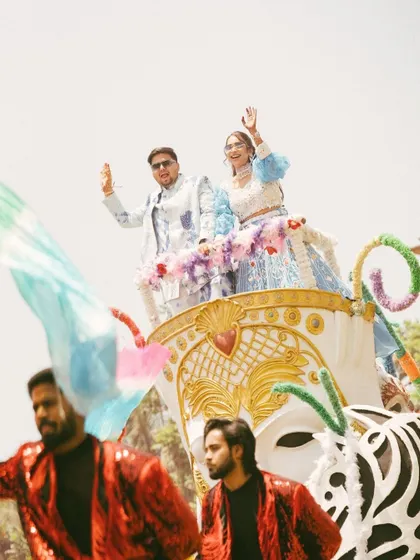 A grand and festive entrance on a beautifully decorated float. This shot captures the energy and excitement of a vibrant wedding procession.