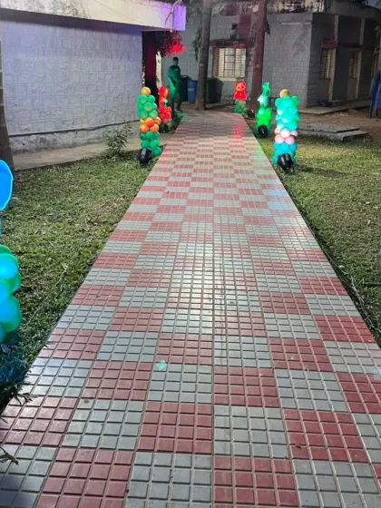 The checkered pathway leading to the event area, flanked by glowing animal props, creating an exciting entrance for a kid's party.