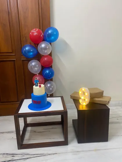 Here's the Roblox theme cake as part of the full birthday setup. Seeing my cake alongside the balloons and gifts, ready for the celebration, is what makes baking so rewarding.