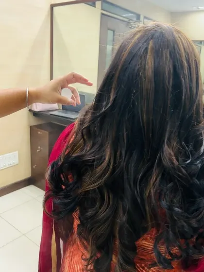 A close-up showing the detail of the highlights and the healthy condition of the hair after coloring and styling. We prioritize teaching hair care alongside chemical services.
