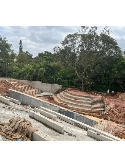 The stepped concrete forms create an amphitheater-like space, integrating the building's circulation with the public realm of the campus.