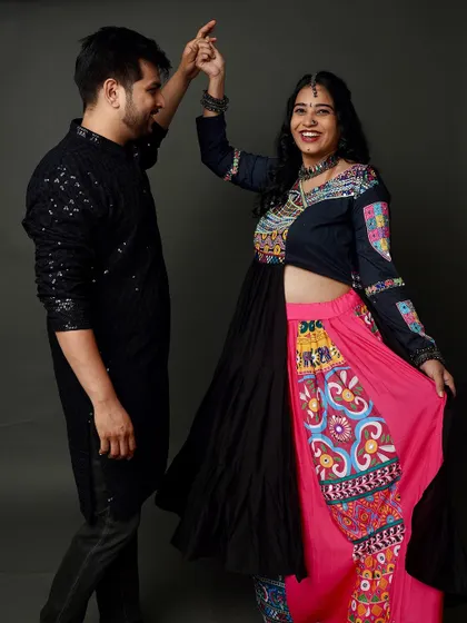 Dancing into parenthood! This dynamic and joyful shot from a Garba-themed maternity session captures the couple's excitement and love for their culture.