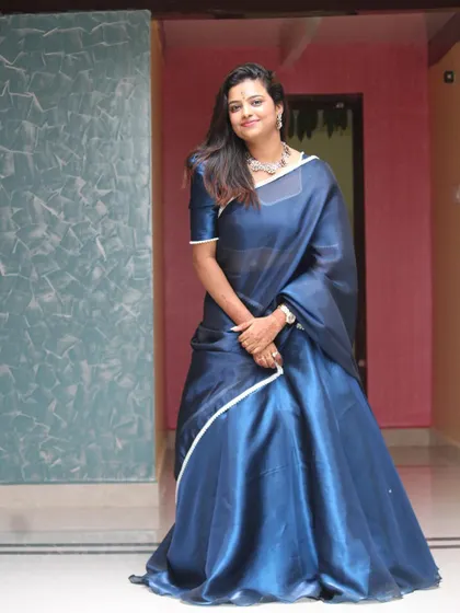 A full-length view of Sonu in the blue Langa Dhawani, showing its beautiful drape and flow.