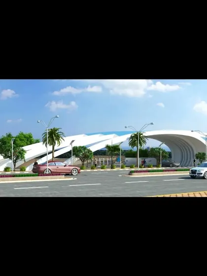 A daytime view of the township entrance gate, showing how it frames the entry road. The design is both functional and artistic, setting a premium tone for the entire community.
