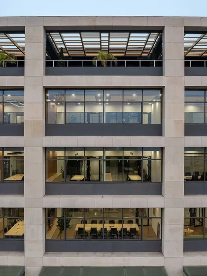 The gridded facade of Laurus Labs creates a strong architectural identity, with deep-set windows that provide shade and large floor plates for flexible office layouts.