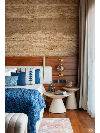 A closer look at the bedside details, featuring unique cone-shaped side tables and delicate glass pendant lights that add a touch of modern elegance.