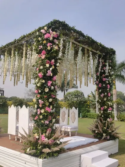 A duplicate image showing the beautiful floral mandap, emphasizing the detail of the flower arrangements on the pillars.