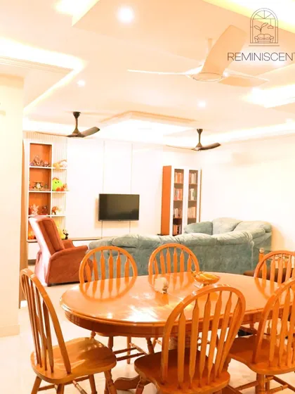 A classic and comfortable living and dining room layout in a Sobha Daffodil apartment. The space is unified by a multi-level false ceiling and features a traditional wooden dining set, perfect for family gatherings.
