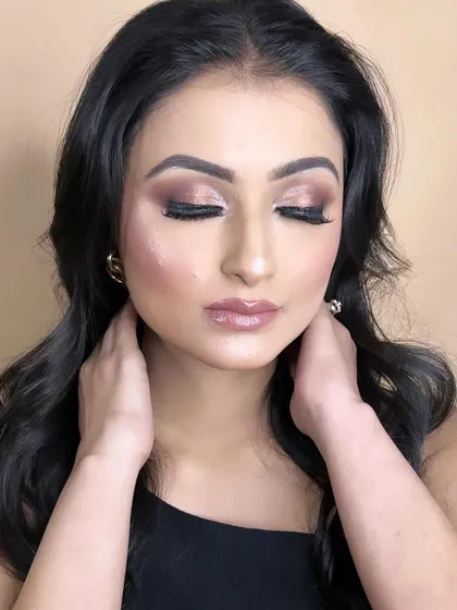 The closed-eye shot highlights the soft brown and champagne tones, a universally flattering combination.