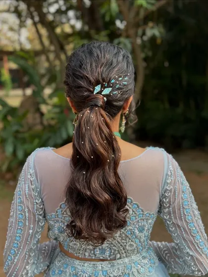 A final shot of the chic ponytail, a perfect choice for a bride or bridesmaid looking for a contemporary and elegant hairstyle.