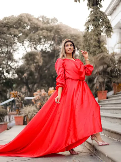 A full-length shot that showcases the entire silhouette of the red dress.