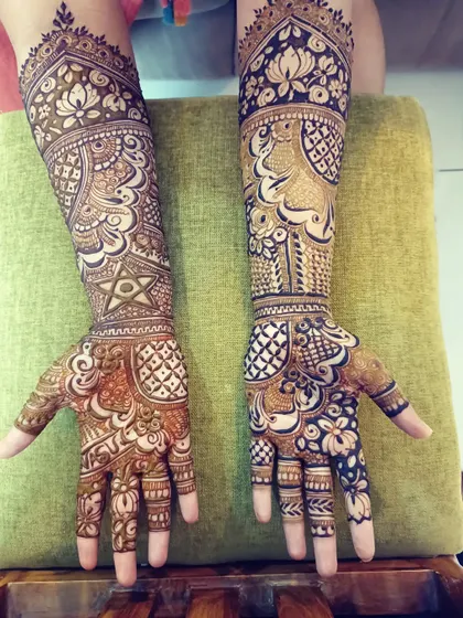 A stunning combination of peacock motifs and geometric patterns. This design blends traditional figures with modern line work for a unique bridal look.