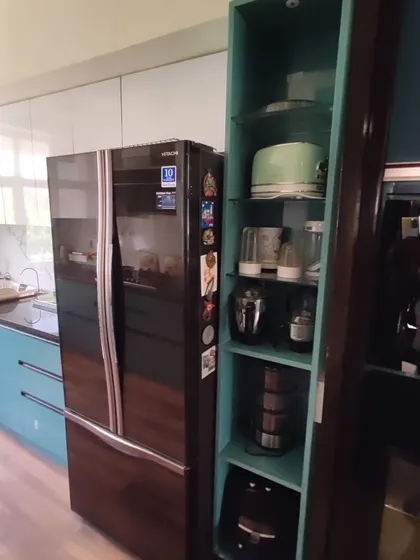 We designed a custom tall unit to house appliances like the microwave and OTG, keeping the countertops free. This unit is seamlessly integrated next to the refrigerator, creating a dedicated zone for all your kitchen electronics.
