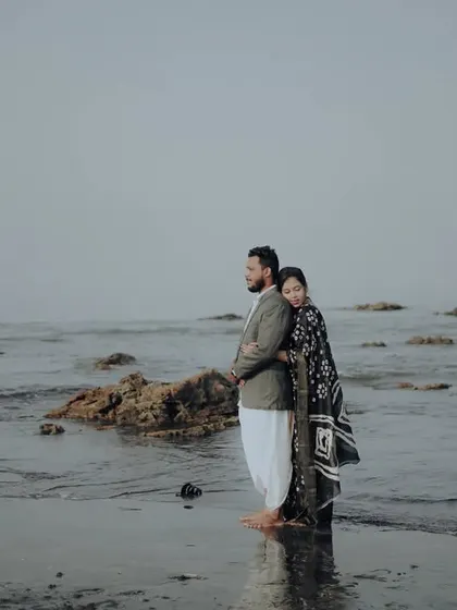A creative pose on the beach, capturing a moment of quiet connection and reflection.