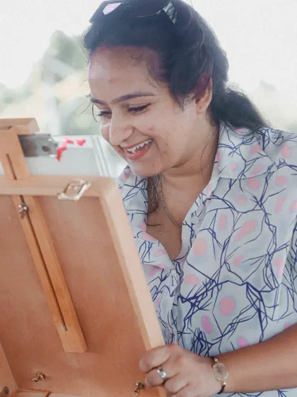 A candid shot of me, smiling as I work. I'm truly grateful for every moment I get to spend drawing.