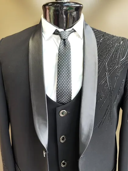 A collection of our designer suits, showcasing a variety of colors, fabrics, and custom details like embroidery, unique lapels, and accessories. Each piece is crafted to make a lasting impression.
