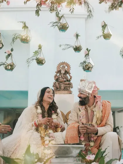 A moment of pure, unscripted laughter during an intimate wedding ceremony in Alibaug. This candid shot captures the couple's joy and the relaxed atmosphere of their special day.