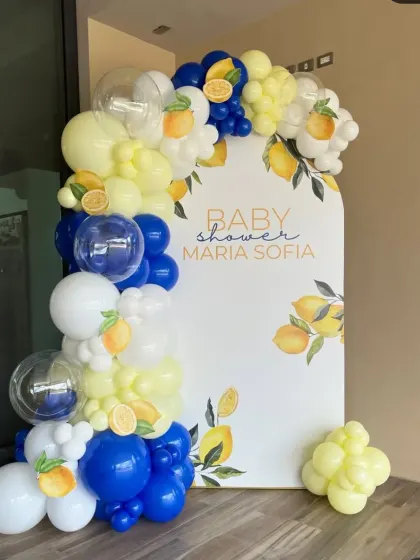 A fresh and stylish lemon-themed baby shower. The unique color combination of royal blue, yellow, and white, paired with a custom-printed backdrop, makes for a very modern and cheerful event.