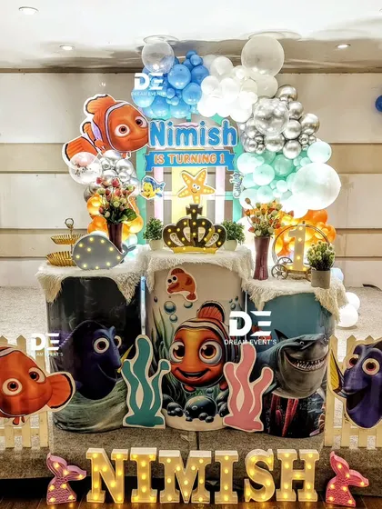 Just keep swimming! A fun 'Finding Nemo' party for Nimish's first birthday, featuring Nemo, Dory, and Bruce the shark, with an underwater-themed stage.