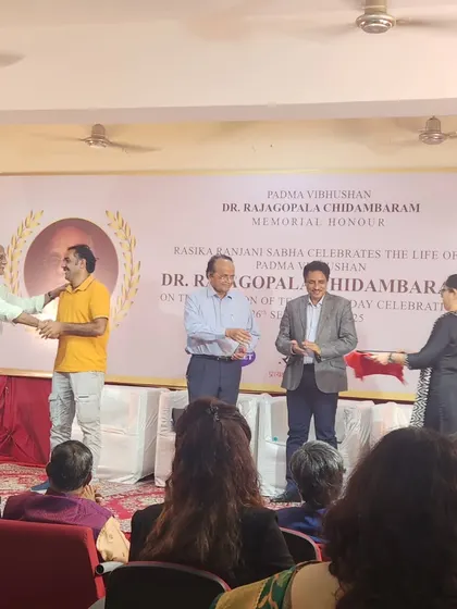 Shaking hands with the dignitaries on stage after being presented with the award.