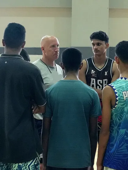 A team huddle with Coach Phil, where he shares insights that go beyond the court.